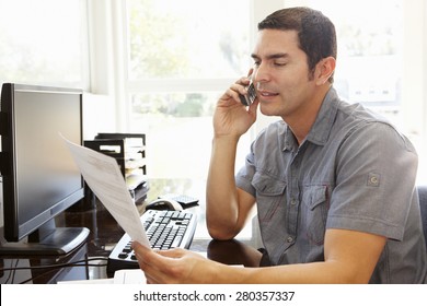 Hispanic Man Working In Home Office