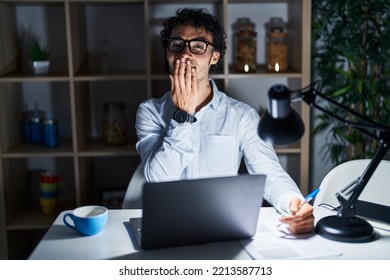 Hispanic Man Working At The Office At Night Laughing And Embarrassed Giggle Covering Mouth With Hands, Gossip And Scandal Concept 