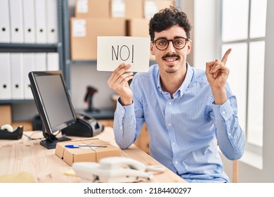 Hispanic Man Working At Small Business Ecommerce Holding No Banner Smiling Happy Pointing With Hand And Finger To The Side 