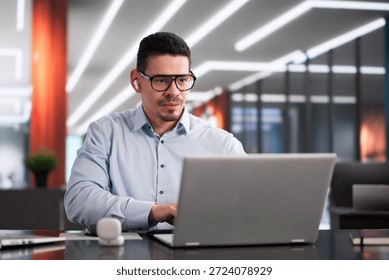 Hispanic Manager Efficiently Coordinating Staff Across Multiple Laptop Computers Latinx Developer Tracking Tasks