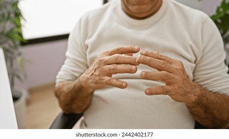 Hispanic mature man clasping hands in a modern office setting, evoking themes of business, contemplation, and professionalism. - Powered by Shutterstock