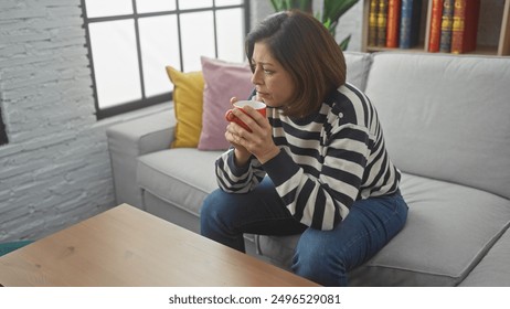 Hispanic mature woman relaxing with coffee in bright, cozy living room. - Powered by Shutterstock