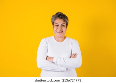 Hispanic Matured Woman Portrait On Yellow Background In Mexico Latin America