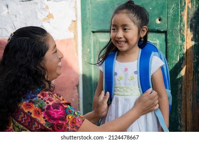 Hispanic Mayan mom getting her little daughter ready for school-little girl with her mom ready to go to preschool