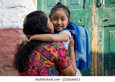 Hispanic Mayan mom hugging her little daughter ready for her first day of school-little girl with her mother ready to go to school- Back to school in Latin America - Shutterstock ID 2120166611