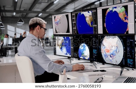 Hispanic Meteorologist Analyzing Hurricane Data On Multiple Screens To Predict Climate Impact