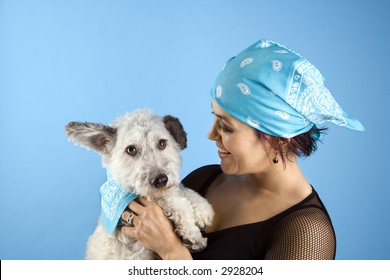 Hispanic Mid-adult Woman Holding Small White Dog Wearing Matching Bandanas.