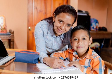 Hispanic Mom Helping Her Little Son Do Her Homework -homeschooling-young Latin Mother And Her Son Learn Online With Tablet At Home.