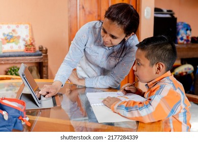 Hispanic Mom Helping Her Little Son Do Her Homework -homeschooling-young Latin Mother And Her Son Learn Online With Tablet At Home.