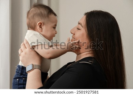 Hispanic mom with her baby - mom playing with her 6 month old baby - single mother with her baby