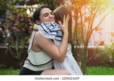 Hispanic Mom Hug Her Daughter In Outside Park Background