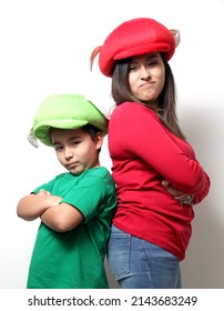 Hispanic mom and son in funny hats play as a family and celebrate their love and friendship with jokes, hugs and games
