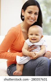 Hispanic Mother And Baby At Home