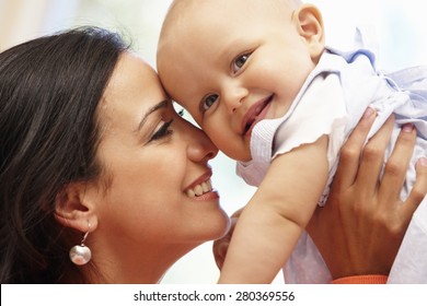 Hispanic Mother And Baby At Home