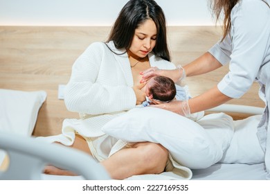 Hispanic mother breastfeeding newborn baby in hospital ward, breastfeeding specialist or nurse help her. - Powered by Shutterstock