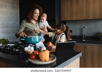 Hispanic mother and child daughter cooking at kitchen in Mexico Latin America