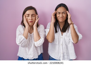 Hispanic Mother And Daughter Together With Hand On Head, Headache Because Stress. Suffering Migraine. 