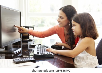 Hispanic Mother And Daughter Using Computer At Home