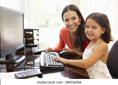 Hispanic Mother And Daughter Using Computer At Home