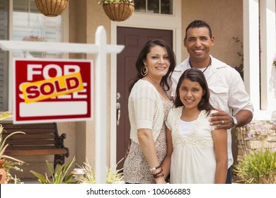 Hispanic Mother, Father and Daughter in Front of Their New Home with Sold Home For Sale Real Estate Sign. - Powered by Shutterstock