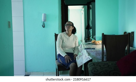 A Hispanic Older Woman Sitting At Home. Latin South American Senior Person Alone