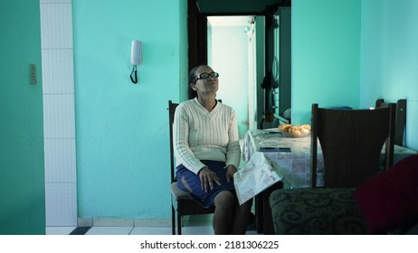 A Hispanic Older Woman Sitting At Home. Latin South American Senior Person Alone