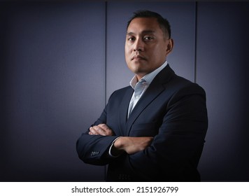 Hispanic Or Pacific Islander Man In Business Suit With Serious And Confident Expression With Modern Background