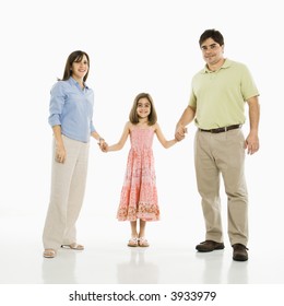 Hispanic Parents And Daughter Holding Hands Standing Against White Background.