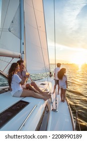 Hispanic Parents Happy Together On Deck Of Luxury Yacht With Son And Daughter Enjoying Family Vacation At Sunset