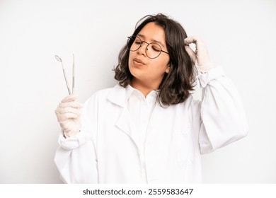 hispanic pretty girl smiling with a happy, confident expression with hand on chin. dentist student concept - Powered by Shutterstock