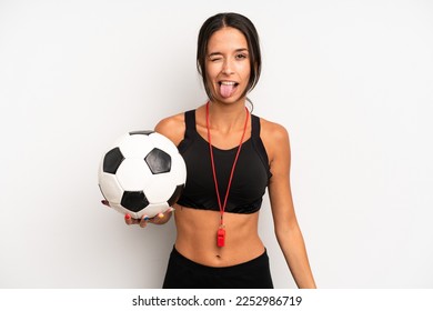 hispanic pretty woman with cheerful and rebellious attitude, joking and sticking tongue out. soccer and fitness concept