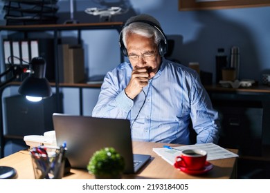 Hispanic Senior Man Wearing Call Center Agent Headset At Night Feeling Unwell And Coughing As Symptom For Cold Or Bronchitis. Health Care Concept. 