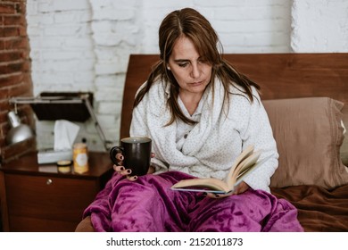 Hispanic Senior Mature Woman Reading A Book In Bed At Home In Mexico Latin America