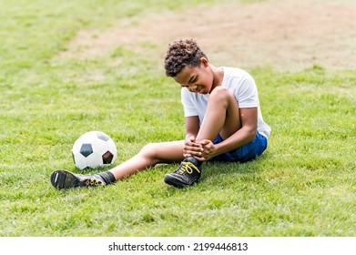 A Hispanic Soccer Player Outdoor In Sunny Day Having Ankle Injury