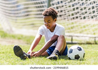 A Hispanic Soccer Player Outdoor In Sunny Day Having Ankle Injury