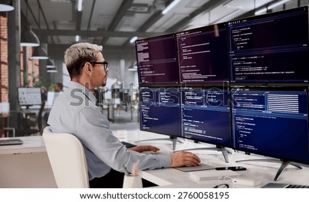 Hispanic Software Engineer Writing Code For Modern Web Apps On Desktop Monitor