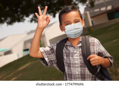 Hispanic Student Boy Wearing Face Mask With Backpack On School Campus.