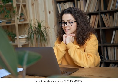 Hispanic teen girl, latin young woman school student, remote worker learning watching online webinar webcast class looking at laptop elearning distance course or video calling remote teacher. - Shutterstock ID 1741950809