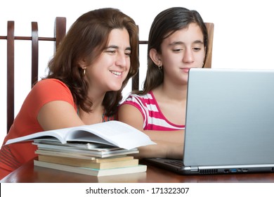 Hispanic Teen And Her Mother Working Or Browsing The Web On A Laptop Computer Isolated On White