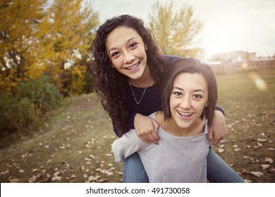 Hispanic Teenage Girls Having Fun Together Outdoors