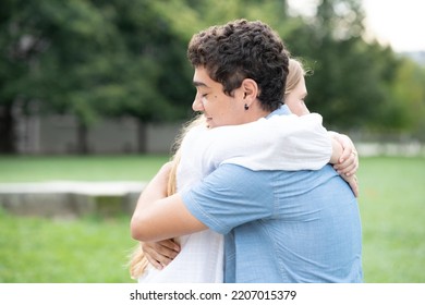 Hispanic Teenager Boy Hugging Girlfriend And Feeling Support. Trust, Unity And Reconciliation Concept.