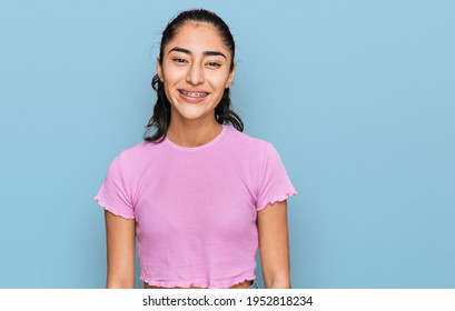 Hispanic Teenager Girl With Dental Braces Wearing Casual Clothes With A Happy And Cool Smile On Face. Lucky Person. 