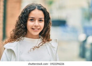 Hispanic Teenager Girl Smiling Happy Standing At The City.