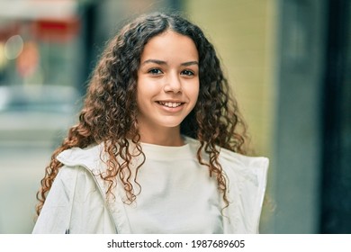 Hispanic Teenager Girl Smiling Happy Standing At The City.