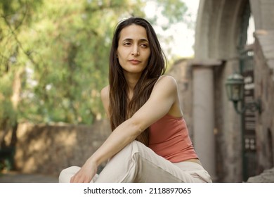 Hispanic Woman, 30 Years Old, Long Straight Hair. Sitting In A P