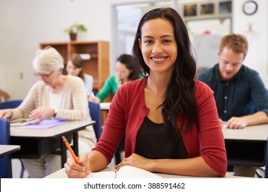 Hispanic Woman At An Adult Education Class Looking To Camera