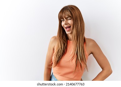 Hispanic Woman With Bang Hairstyle Standing Over Isolated Background Looking Away To Side With Smile On Face, Natural Expression. Laughing Confident. 