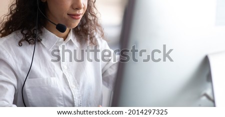 Hispanic woman call center service support in headset. Female customer support or sales agent. 