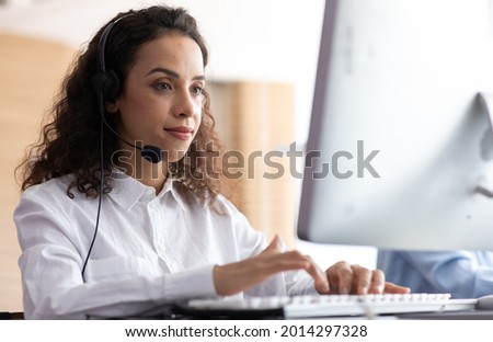 Hispanic woman call center service support in headset. Female customer support or sales agent. 