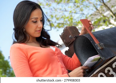 Hispanic Woman Checking Mailbox